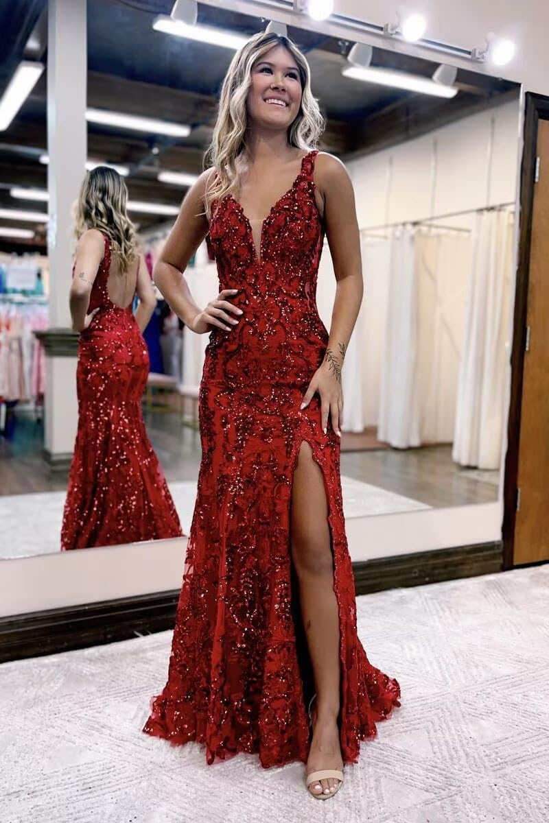 Woman in a red evening gown with a high slit standing in front of a mirror.